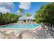 Community pool with surrounding patio and lounge chairs at 2511 Dolly Bay Dr # 308, Palm Harbor, FL 34684