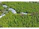 Aerial view of condo community with pool, dock, and lush landscaping at 2511 Dolly Bay Dr # 308, Palm Harbor, FL 34684
