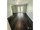 Bedroom with dark hardwood floors and built-in shelving at 2013 Finland Dr, Spring Hill, FL 34609