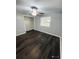 Large bedroom with dark laminate wood flooring and a spacious closet at 2013 Finland Dr, Spring Hill, FL 34609