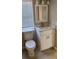 Bathroom with white vanity, toilet and window at 2013 Finland Dr, Spring Hill, FL 34609