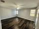 Bright bedroom with dark hardwood floors and ceiling fan at 2013 Finland Dr, Spring Hill, FL 34609