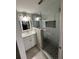 Updated bathroom with white vanity, glass shower, and modern hexagonal floor tiles at 2013 Finland Dr, Spring Hill, FL 34609