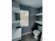 Small bathroom with floating shelves, toilet and window at 2013 Finland Dr, Spring Hill, FL 34609