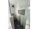 Modern glass shower with hexagonal tile floor and niche at 2013 Finland Dr, Spring Hill, FL 34609