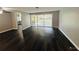 Spacious living room with dark hardwood floors and sliding doors to a patio at 2013 Finland Dr, Spring Hill, FL 34609