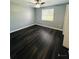Bright bedroom with dark laminate flooring, ceiling fan, and window coverings at 2013 Finland Dr, Spring Hill, FL 34609