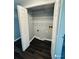 Laundry room with wire shelving and dark laminate flooring at 2013 Finland Dr, Spring Hill, FL 34609