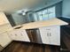 Updated kitchen with an island, stainless steel appliances, and white cabinets at 2013 Finland Dr, Spring Hill, FL 34609