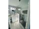 Updated bathroom with white vanity, glass shower, and modern hexagonal floor tiles at 2013 Finland Dr, Spring Hill, FL 34609