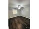 Bedroom with dark laminate flooring, a ceiling fan, and a window at 2013 Finland Dr, Spring Hill, FL 34609