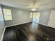 Bedroom with dark hardwood floors and sliding doors to patio at 2013 Finland Dr, Spring Hill, FL 34609
