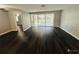 Spacious living room with dark hardwood floors and sliding doors to a patio at 2013 Finland Dr, Spring Hill, FL 34609