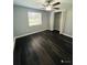 Spacious bedroom featuring dark laminate flooring and ample closet space at 2013 Finland Dr, Spring Hill, FL 34609