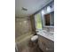 Bathroom with tub, toilet and vanity with white cabinets at 2013 Finland Dr, Spring Hill, FL 34609