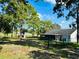 Fenced backyard with a screened porch and storage shed at 2013 Finland Dr, Spring Hill, FL 34609