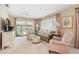 Bright living room with comfy seating and a view to screened porch at 13002 Wedgewood Way # D, Hudson, FL 34667