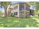 Exterior view of condo with well-maintained lawn at 13002 Wedgewood Way # D, Hudson, FL 34667