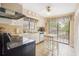 Galley kitchen with white cabinets, and a breakfast bar at 13002 Wedgewood Way # D, Hudson, FL 34667