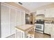 Bright kitchen features white cabinets and a breakfast bar at 13002 Wedgewood Way # D, Hudson, FL 34667