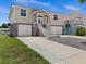 Two-story home with double garage, front porch, and landscaped yard at 7332 Islander Ln, Hudson, FL 34667