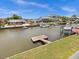 View of the canal with boats and neighboring houses at 7332 Islander Ln, Hudson, FL 34667