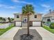 Two-story house with double garage, front porch and landscaping at 7332 Islander Ln, Hudson, FL 34667