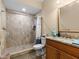 Updated bathroom with a large walk-in shower and granite vanity at 7332 Islander Ln, Hudson, FL 34667