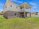 Two-story house with a large covered patio and grassy backyard at 7332 Islander Ln, Hudson, FL 34667