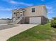 Tan two story house with double garage and landscaping at 7332 Islander Ln, Hudson, FL 34667
