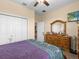 Bedroom with a large dresser and ceiling fan at 7332 Islander Ln, Hudson, FL 34667