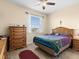 Comfortable bedroom with a dresser and ceiling fan at 7332 Islander Ln, Hudson, FL 34667