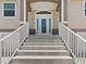 Steps leading to the front door of a two-story house at 7332 Islander Ln, Hudson, FL 34667