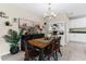 Farmhouse style dining room with wooden table and white hutch at 2132 Shining Azul Way, Lutz, FL 33558