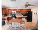 Cozy kitchen with wood cabinets and a breakfast nook at 10526 Mira Vista Dr, Port Richey, FL 34668