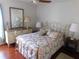 Bright bedroom with a floral bedspread and matching decor at 10526 Mira Vista Dr, Port Richey, FL 34668