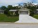 Single-story home with attached garage and neat landscaping at 10526 Mira Vista Dr, Port Richey, FL 34668