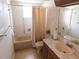 Clean bathroom with shower/tub combo, vanity, and tile flooring at 10526 Mira Vista Dr, Port Richey, FL 34668