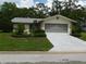 Single story home with attached garage and landscaping at 10526 Mira Vista Dr, Port Richey, FL 34668