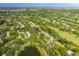 Aerial view of house and surrounding area, including golf course and lake at 12709 Clock Tower Pkwy, Hudson, FL 34667