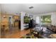 Living area with a view into the kitchen and backyard pool at 12709 Clock Tower Pkwy, Hudson, FL 34667