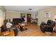 Spacious living room featuring hardwood floors and leather furniture at 12709 Clock Tower Pkwy, Hudson, FL 34667