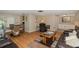 Open living room with hardwood floors and a view of the dining area at 12709 Clock Tower Pkwy, Hudson, FL 34667