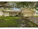 Ranch-style home with mature landscaping and a two-car garage at 12709 Clock Tower Pkwy, Hudson, FL 34667