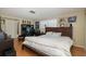 Spacious Primary bedroom with a king-size bed and wood floors at 12709 Clock Tower Pkwy, Hudson, FL 34667