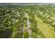 Aerial view of home and neighborhood near golf course and lake at 12709 Clock Tower Pkwy, Hudson, FL 34667