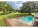 Aerial view of refreshing pool, surrounded by lush greenery at 12709 Clock Tower Pkwy, Hudson, FL 34667