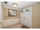 Bright entryway with tile flooring, double doors, and a mirror at 12709 Clock Tower Pkwy, Hudson, FL 34667