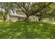 Single story home nestled under large oak trees at 12709 Clock Tower Pkwy, Hudson, FL 34667