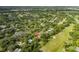 Aerial view showcasing home's location near golf course and lake at 12709 Clock Tower Pkwy, Hudson, FL 34667